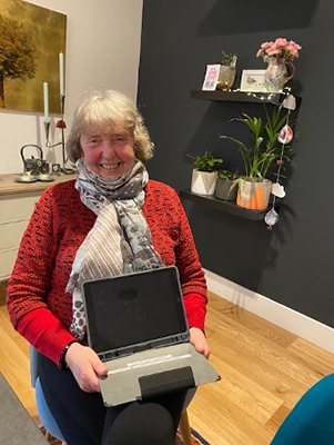 Computer Delivery recipient Pat holding her iPad