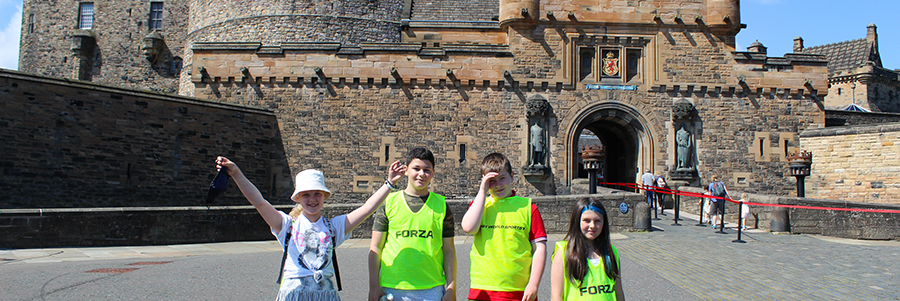 A group of young people standing in front of Edinburgh Castle in the Positive Transitions summer programme