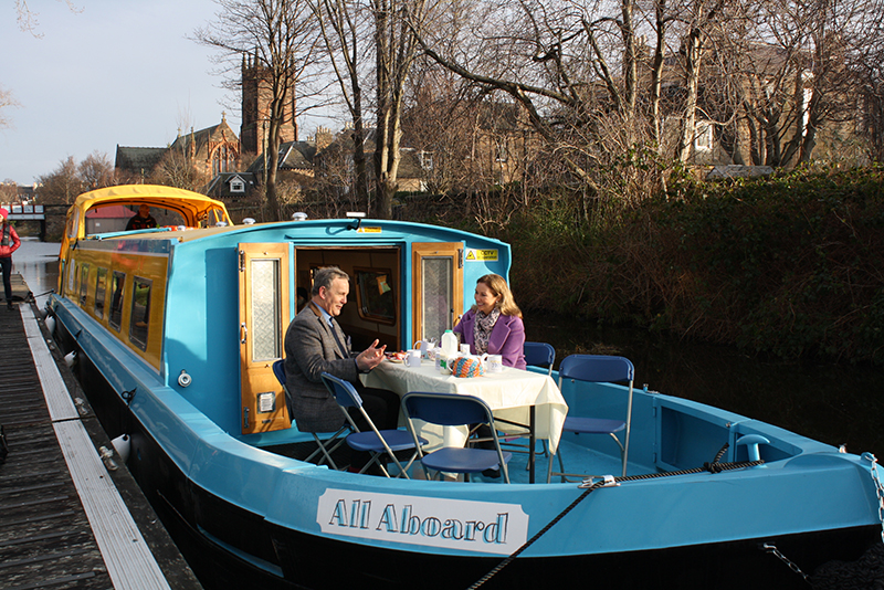 Reverend Jack Holt and a BBC presenter having tea on the All Aboard canalboat