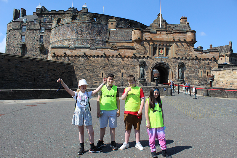 A group of young people standing in front of Edinburgh Castle at the Positive Transitions summer programme