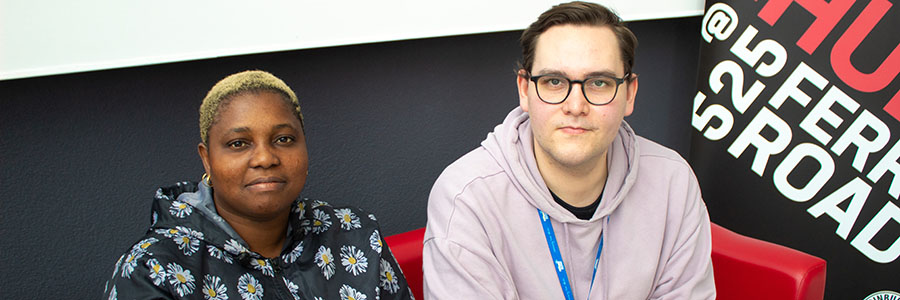 A Reconnect Digital & Wellbeing Coordinator sitting beside a person receiving digital inclusion support