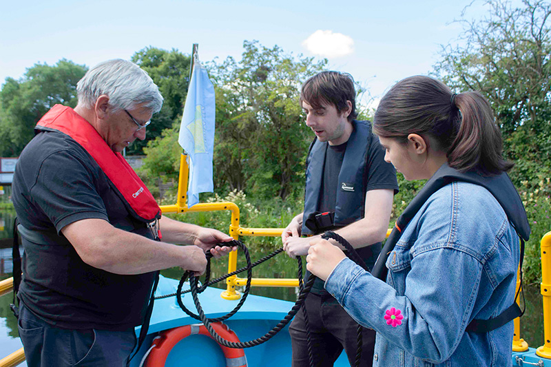 Two People Know How volunteers learning how to tie knots on the All Aboard canal boat