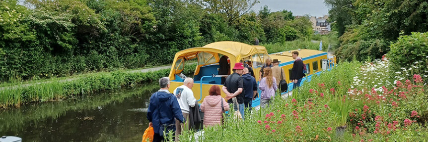 A group of people preparing to board the All Aboard canal boat