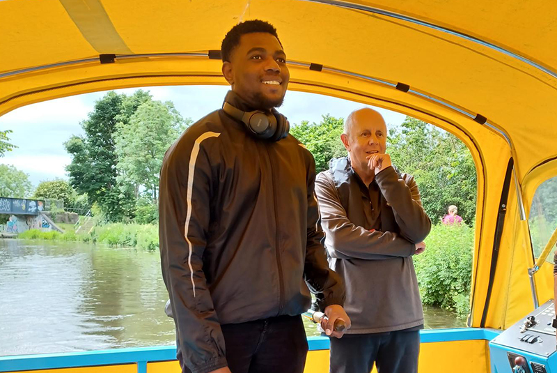 A Reconnect team member driving the All Aboard canal boat