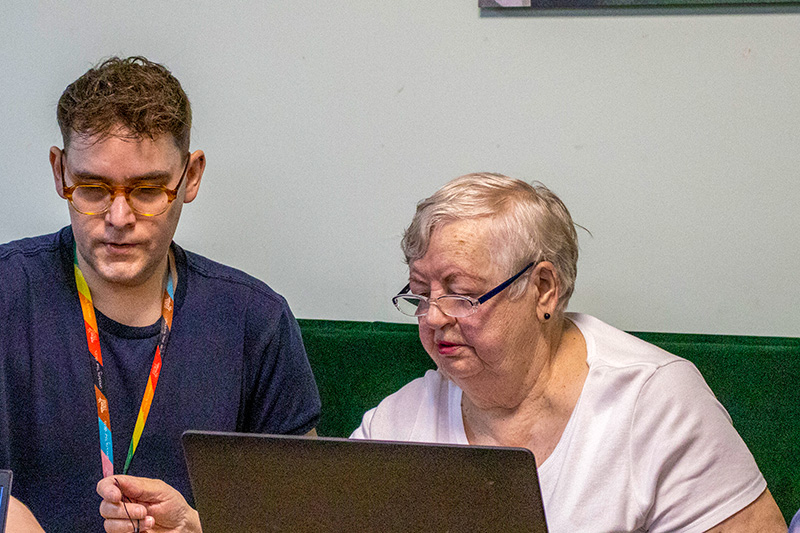 Two people looking at a laptop