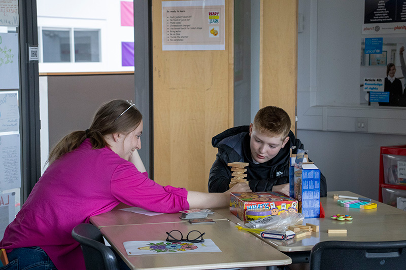 A coordinator and a young person at a table at a Positive Transitions session