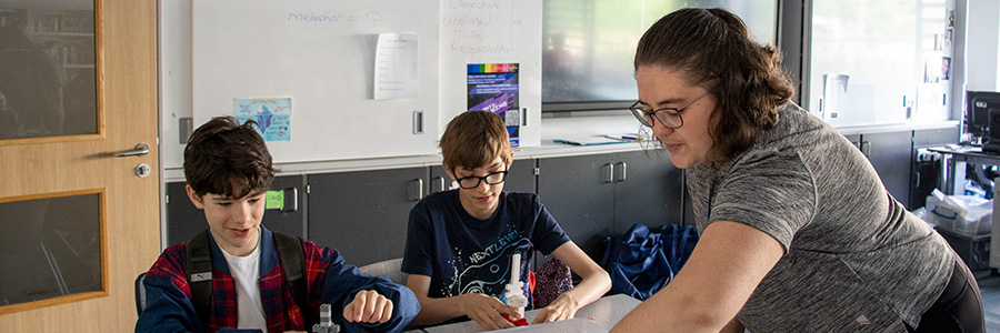 A coordinator and two young people at a table at a Positive Transitions session