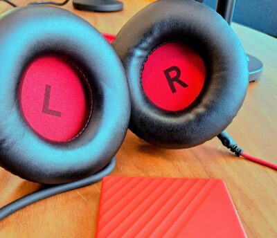 A pair of headphones on a desk in the People Know How recording studio, ready to create a podcast